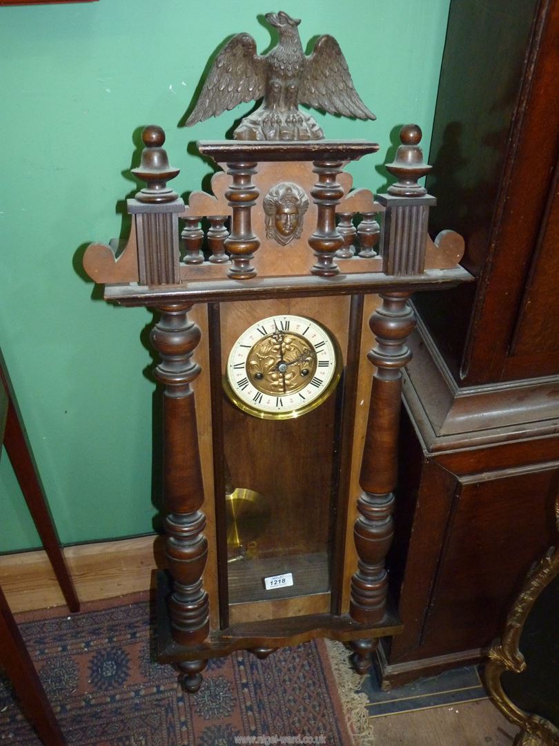 A mixed woods Vienna type Wall Clock having a two train spring driven movement with Roman numerals