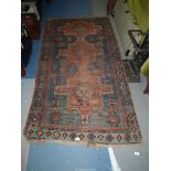 A border pattern rug in blue ground with red and cream geometric patterns, worn condition,