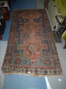 A border pattern rug in blue ground with red and cream geometric patterns, worn condition,