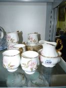A hand painted china coffee set with dog roses, plus a sugar bowl marked D.M. Churchill.