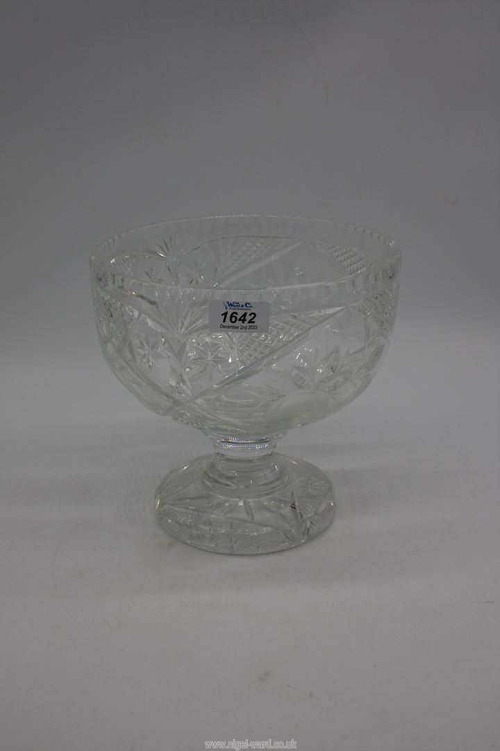 A large footed crystal bowl with star cuts and fruit detail, 8 1/2" high x 9" diameter.