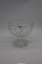 A large footed crystal bowl with star cuts and fruit detail, 8 1/2" high x 9" diameter.