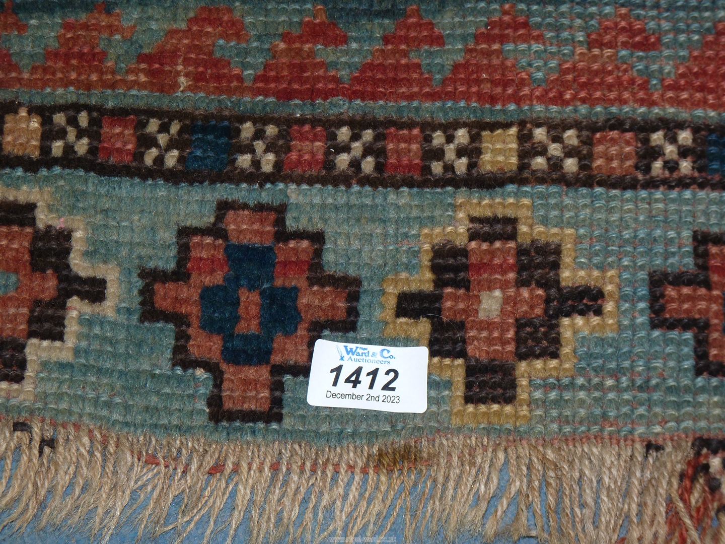 A border pattern rug in blue ground with red and cream geometric patterns, worn condition, - Image 2 of 4
