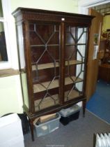 An elegant dark Mahogany china display Cabinet having blind fretwork details and having a pair of