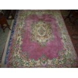 A large pink Chinese carpet, 140" long x 103 1/2'' wide.