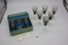 A set of six smoked glass dessert wine Goblets with clear spiral stems and a boxed Irish coffee set