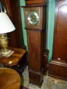 An Oak grandmother's Clock having a three train movement with Roman numerals,