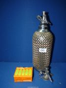 A circa 1930's Soda Syphon with metal grill and a box of Sparklets cylinders.