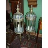 A large pair of ornate panelled glass lamps on stands, 42" tall.