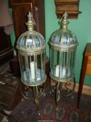 A large pair of ornate panelled glass lamps on stands, 42" tall.