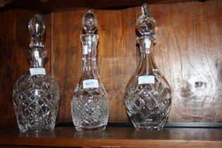 Three cut glass decanters.