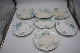 Ten floral plates with gilt rim, some crazing, 9 3/4" and 10 1/2" diameter.