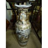 A contemporary Oriental vase with gilded floral decoration and depicting ladies, 24" tall.