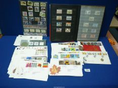 A blue Stockbook with English stamps and quantity of First Day covers including 'Tree and Leaf',
