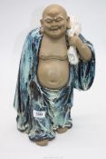 A heavy blue robed pottery Buddha, 15" tall.