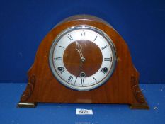 An Anvil wooden mantle clock with key and pendulum, 13'' wide x 8 1/2'' high.