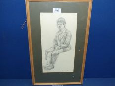 A framed and mounted Pencil sketch of a young man in a seated position, signed lower right J.