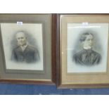 Two wooden framed black and white Portraits of a lady and gentleman taken from photographs.