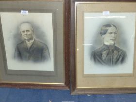 Two wooden framed black and white Portraits of a lady and gentleman taken from photographs.