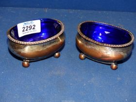 A pair of silver plated Salts with blue glass liners.