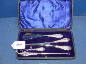 A cased set of silver handled shoe horn, glove stretcher and button hooks.