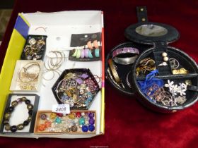 A quantity of costume jewellery including rings and earrings, bangles, gold plated watch strap, etc.