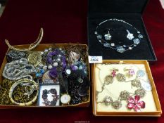 A box of costume jewellery including a floral filigree necklace, sterling silver club tags,