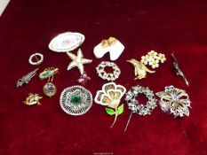 A quantity of brooches including novelty penguin, ship, china terrier head, circular, etc.