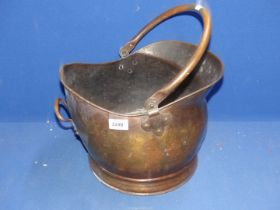 A copper coal scuttle.