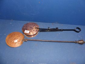 A copper chestnut roaster and skimmer.