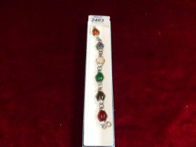 A pretty Arts & Crafts silver bracelet, set with different coloured oval polished agates.