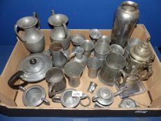 A quantity of pewter including a pair of hammered urns, beakers, oil lamp and tankards,