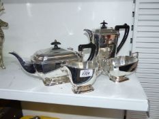 A four piece plated tea set in Art Deco style with black Bakelite handles.