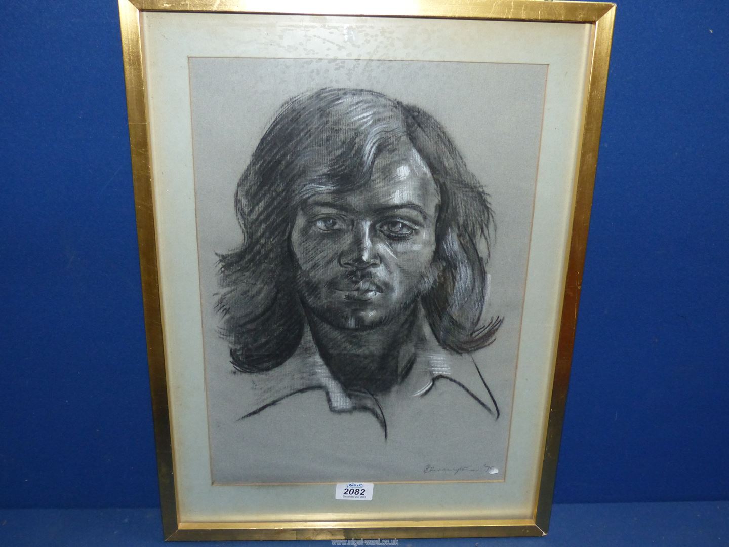 A framed and mounted Charcoal portrait of a gentleman, signed lower right J.