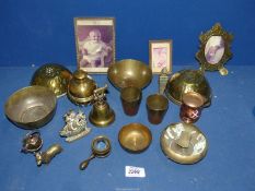A quantity of brass items to include; picture frames, a bell, four bowls, Corgi dog, etc.