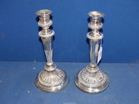 A pair of George IV Silver Candlesticks having weighted base and half ribbed stem,