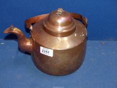 A copper Kettle having lidded spout and swing handle.