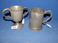A Victorian two handled Pewter Cup and an Edward VI pewter pint tankard, signed inside to the base.