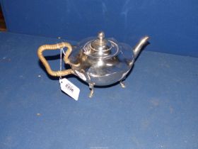 A Silver Teapot with wicker banded handle (loose) standing on hoof feet, Birmingham 1909, makers J.
