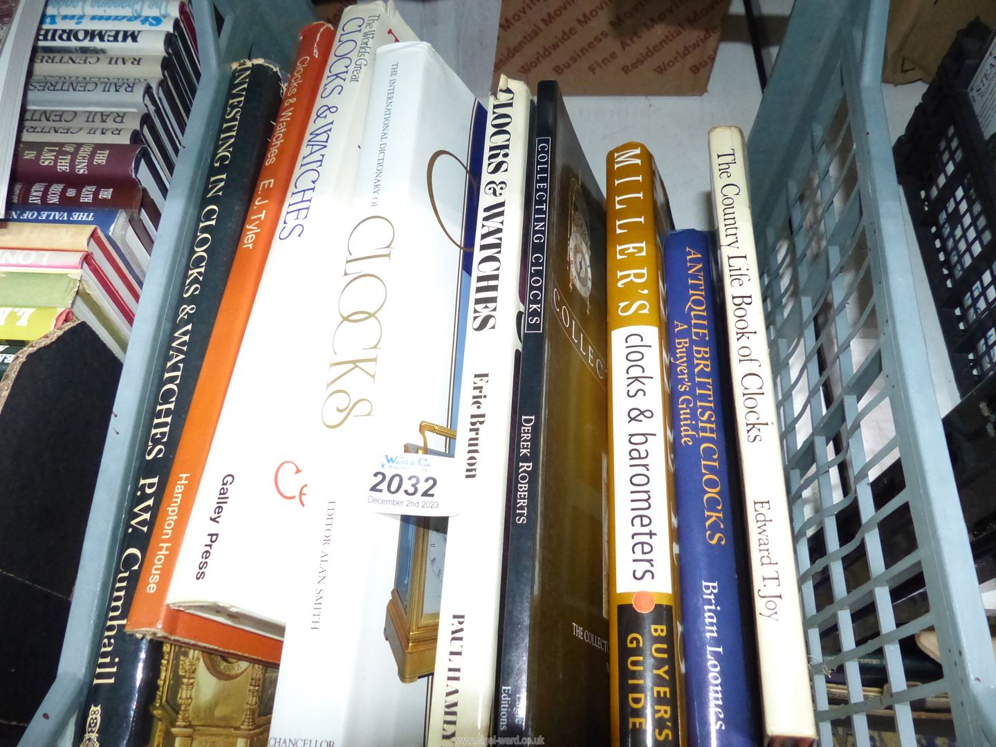 A crate of books on Horology including Buyer's Guides, Investing in Clocks and Watches, etc.