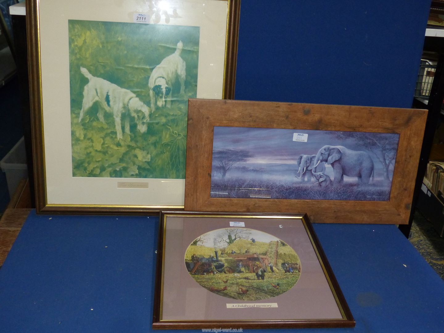 A framed print titled "The Two Sportsmen" along with a print "Gentle Giant Elephants" by Ruane