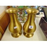 A pair of brass vases,