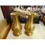 A pair of brass vases,