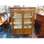 An Edwardian inlaid two door display cabinet