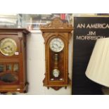 An Oak cased wall clock