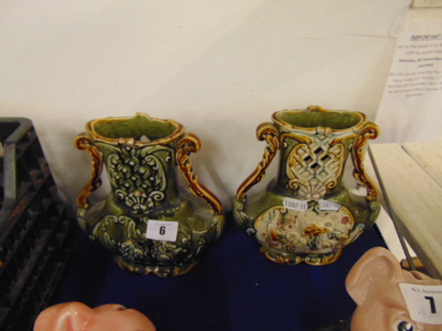 A pair of twin handled vases,