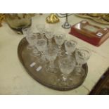 An Oval plated tray with a set of glasses