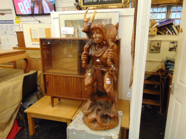 A carved wooden statue Native American