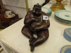 A bronze seated man