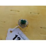 An 18ct Gold, baguette Diamond and Emerald ballerina ring,